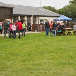 People arriving and braving the rain