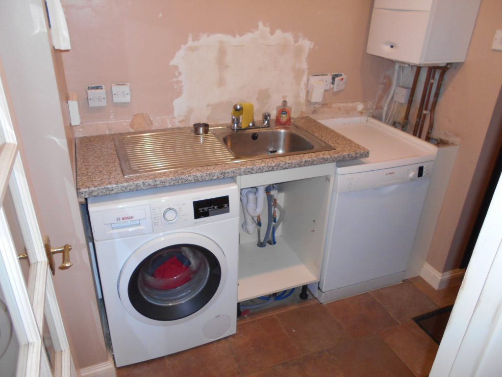Keith Holder Kitchens Plastering where tiles taken off in Utility Room